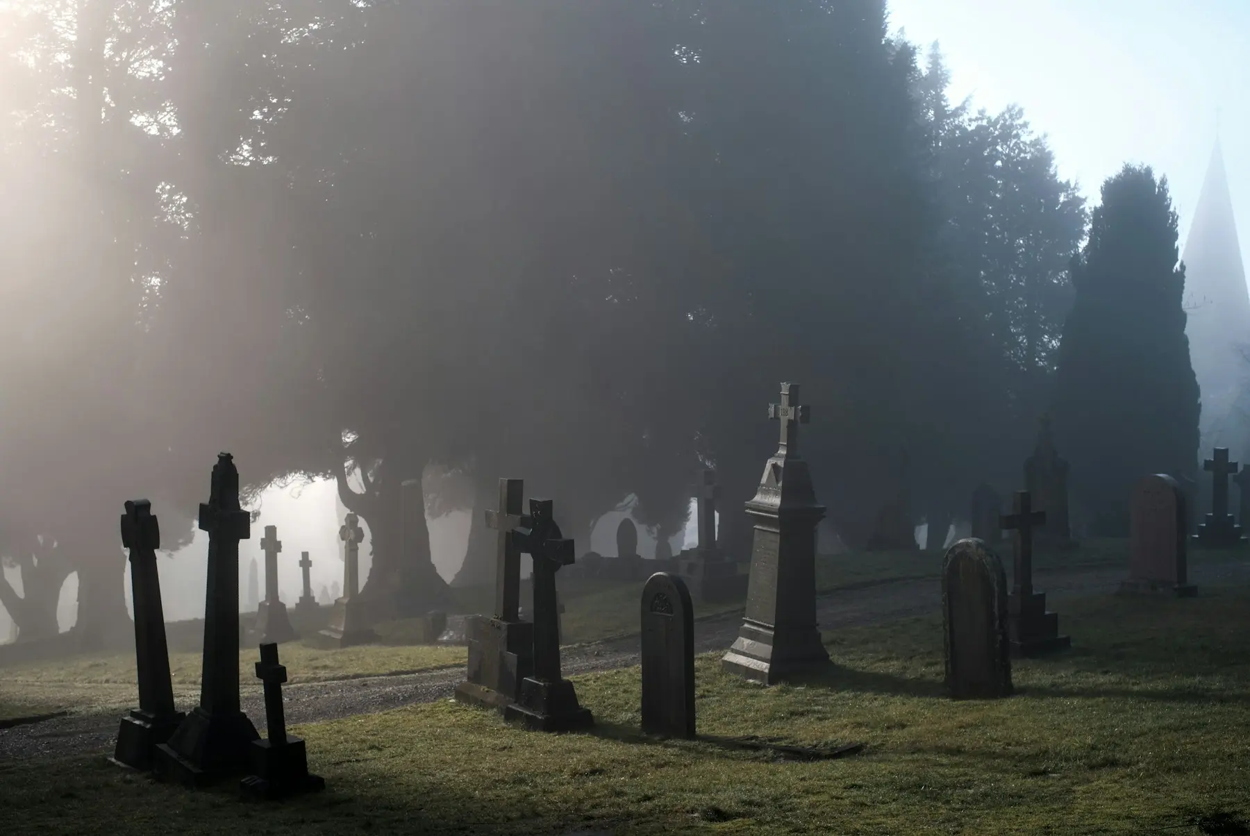 A foggy cemetery in Penrith with gravestones fading into the mist.